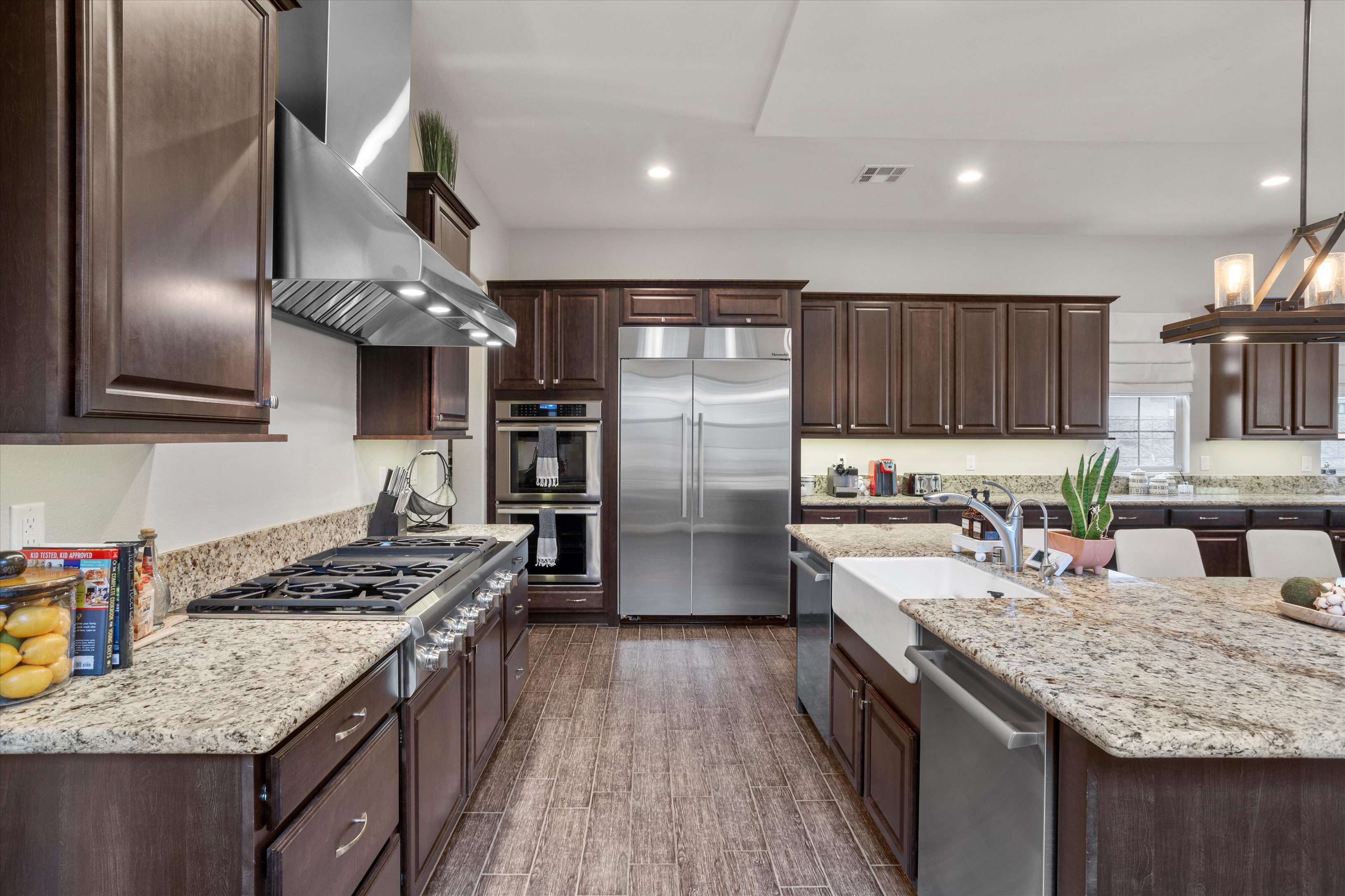 Gourmet kitchen with a 48-inch range, double ovens, dual dishwashers, and an oversized island