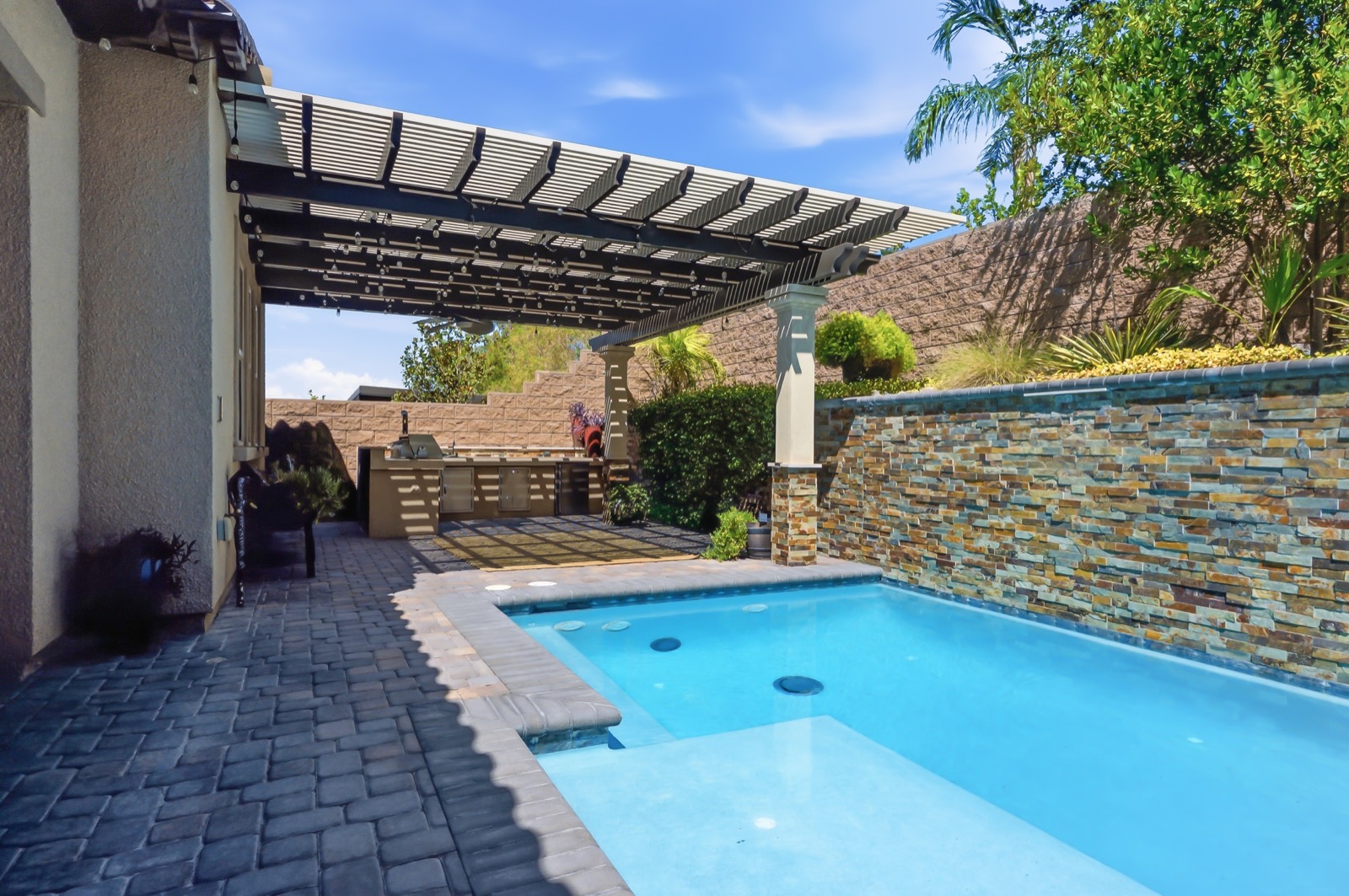 Resort-style pool and spa with stone water feature